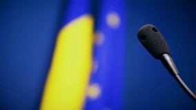 Focus changes on press conference microphones and European Union and Romania's flags
