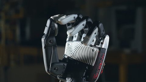 Real innovative bionic cybernetic man gesturing. Futuristic arm moving fingers. Close up. วิดีโอสต็อก