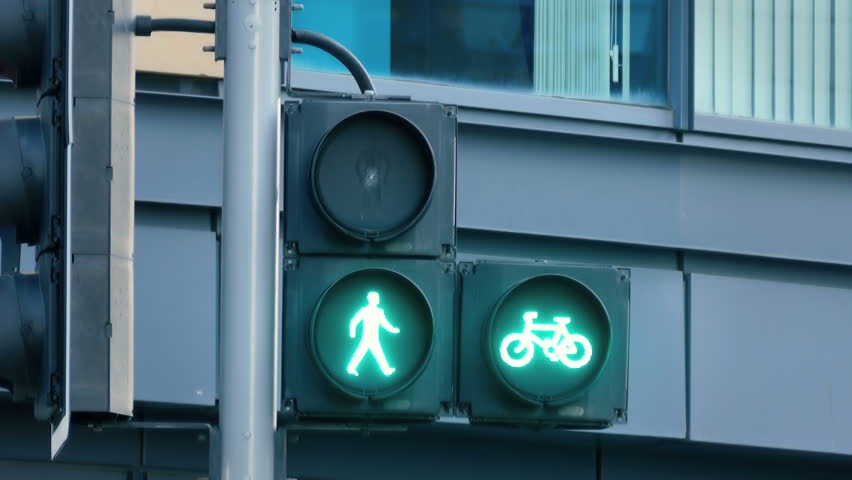 Traffic light turns red to green to signal pedestrians and bicyclists to go
