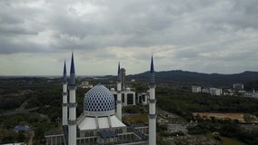 Aerial Video - Aerial View of Sultan Sallehuddin Abdul Aziz Shah Mosque, Shah Alam, Malaysia during a cloudy day. Ungraded and flat footage.