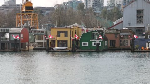 VANCOUVER - FEBRUARY 28, 2017: A Vancouver Aquabus or water taxi moves from left to right in the downtown False Creek area on February 28, 2017.
