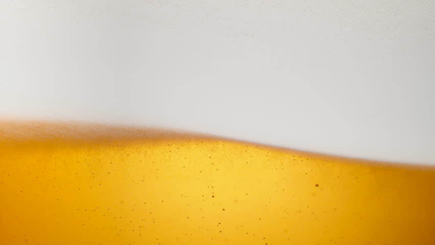 Extream close-up beer in glass. Foam moving. Shot with high speed camera, phantom flex 4K. Slow Motion. Royalty-Free Stock Footage #24422711