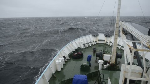 Big wave rolling over the snout of the ship