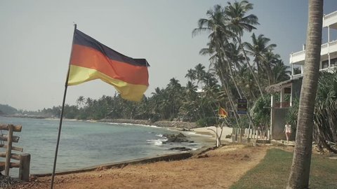Germany Flag on beach background near ocean