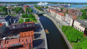 Aerial view opens to the Klaipeda City old town, river, bridge, cruise ship, lagoon and the sea