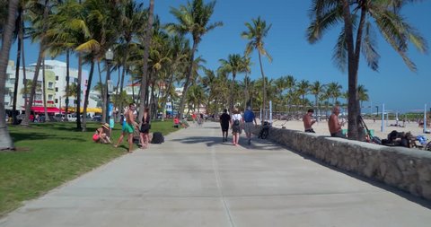 MIAMI BEACH, USA - FEBRUARY 26, 2017: Stabilized motion video of tourists walking along Ocean Drive South Beach Miami FL, USA
