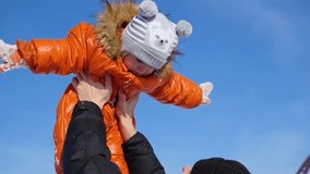Man playing with your child in a sunny winter time. Holding in his arms. Winter landscape. 2 videos in 1