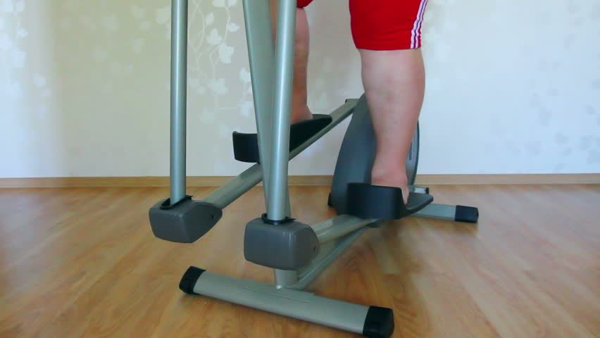 overweight woman legs exercising on trainer ellipsoid