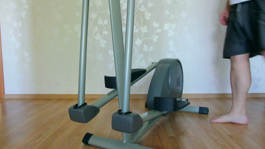 overweight man legs exercising on trainer ellipsoid