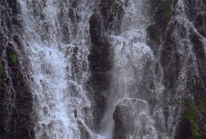 Splashing waterfall down cliff side