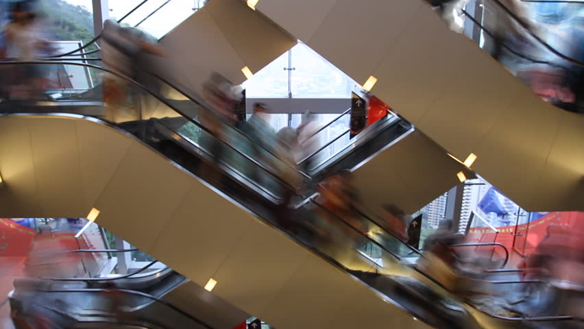 Time lapse of Escalator stairs with crowds of blurred people in the shopping