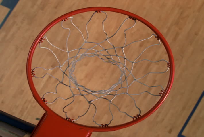 Overhead slow motion view through basketball hoop: ball not going in