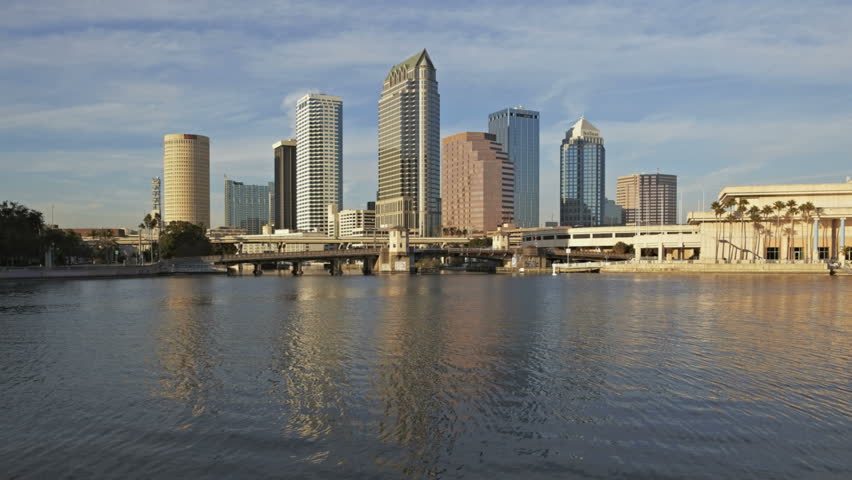 TAMPA - DEC 29: Timelapse of Sunset over water in front of modern skyscrapers on