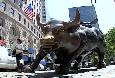 NEW YORK - Circa 2002: Charging Bull bronze statue in front of the New York Stock Exchange building in 2002.
