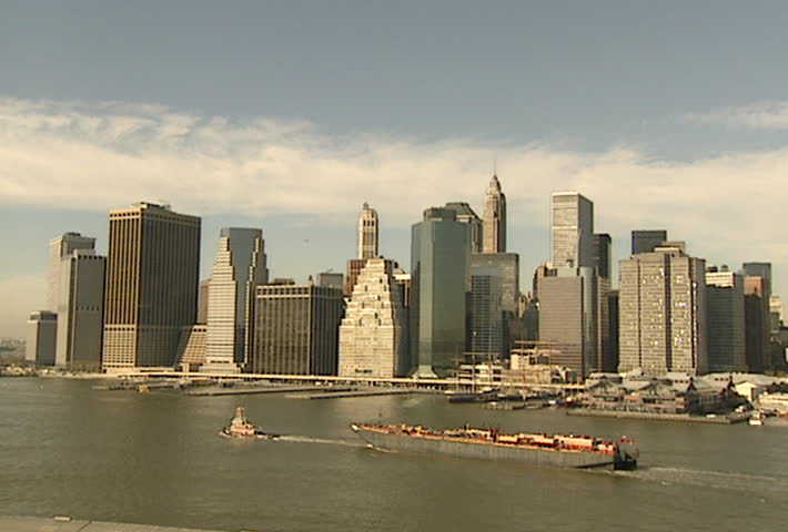 NEW YORK - Circa 2002: Barge in the Hudson River with the Downtown Manhatten skyline in 2002.