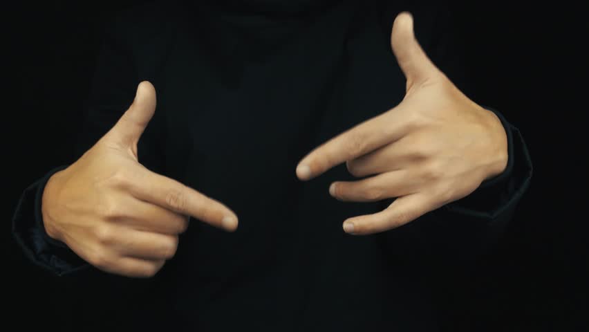 Caucasian male hand in long sleeve jacket making hip hop finger show off gestures on black background, close up isolated