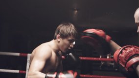 Boy practicing boxing with trainer