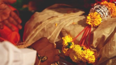 Indian wedding ritual / bride and groom joining hands during an Indian wedding ritual