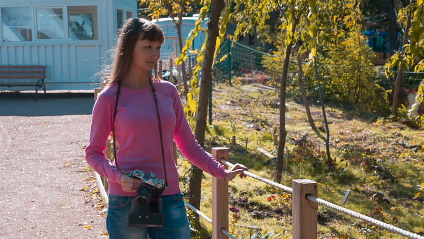 Girl with retro camera in trailer park