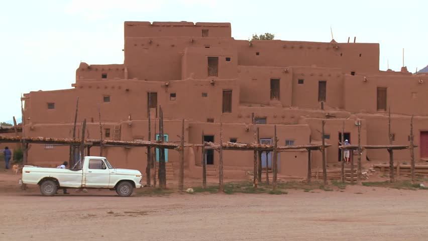 A pickup truck parked in front of Taos Pueblo New Mexico
