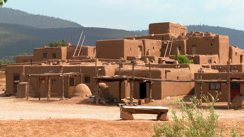 A dog walks by Taos Pueblo New Mexico