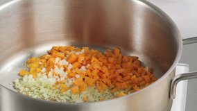 Sweating finely chopped vegetables in a pan