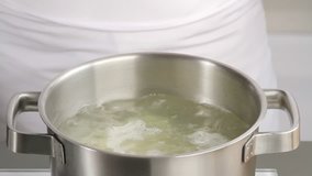 Placing chopped potato into boiling water