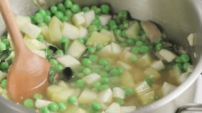 Pouring stock into pea soup