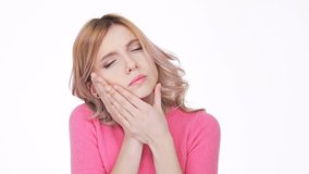 Woman in pink sweater with severe toothache
