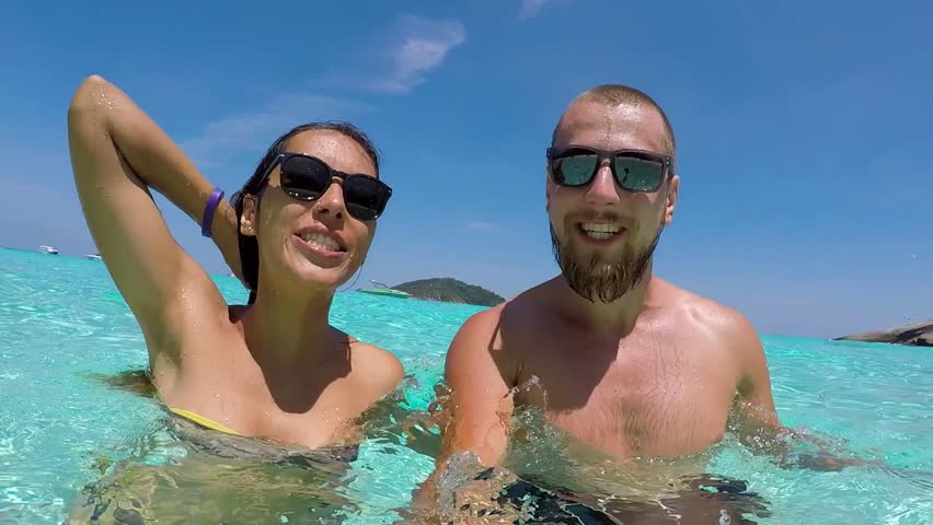 Young Happy Couple in Sunglasses Making Funny Underwater Selfie with GoPro Camera. HD Slow Motion. Thailand. Royalty-Free Stock Footage #24475595