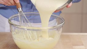 Egg cream being stirred into creamed butter