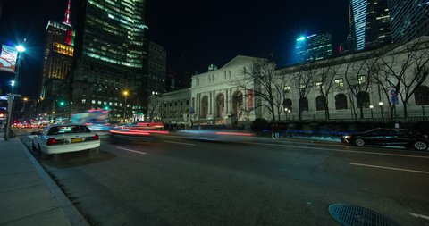 Manhattan, New York City, USA - 5th Avenue in front of New York Public Library with traffic and view to illuminated Empire State Building at night - Timelapse without motion - 01/2016