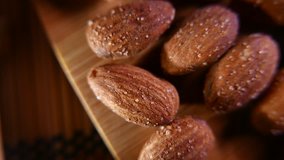Almonds and sweets on a wooden background. Closeup 4K UHD