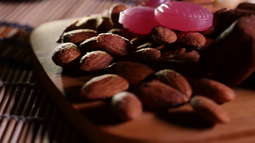 Almonds and sweets on a wooden background. 4K UHD | Shutterstock HD Video #24483935