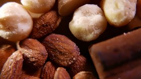 Almonds and sweets on a wooden background. Closeup 4K UHD