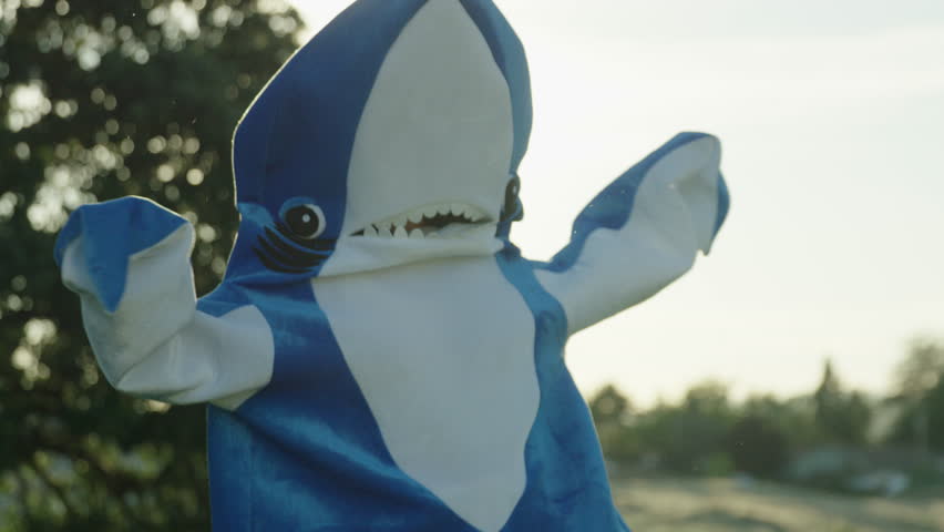 Woman in Blue Shark Costume Dances Around in Sunlight