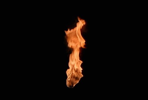 A wall torch burning in center of frame