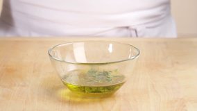 A herb dressing being stirred