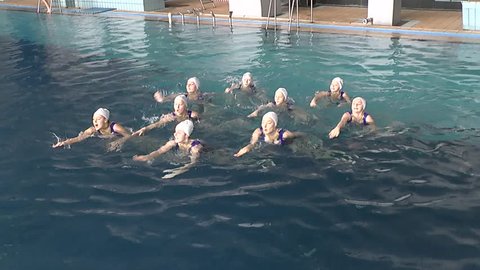 Synchronized swimming, team training, shooting above the water surface.
