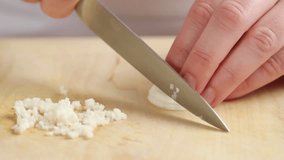 Chopping garlic cloves finely