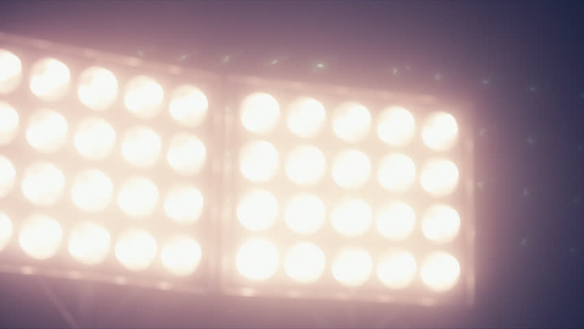 CU Silhouette of male American football player rising a ball in his hand against bright stadium illumination lights Royalty-Free Stock Footage #24497540