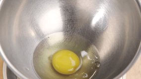 Crack eggs into a mixing bowl