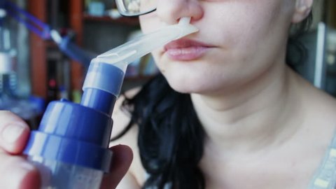 young girl inhales medication through a nebulizer asthma, bronchospasm, bronchitis, cough.Full HD 1920 x 1080, 29,97 fps