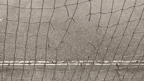 Broken auxiliary net of soccer goal frame close-up 