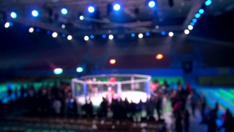 mma cage arena octagonal ring for fights. Mixed Martial arts fight. Light beams flashing spotlights. Blurred.