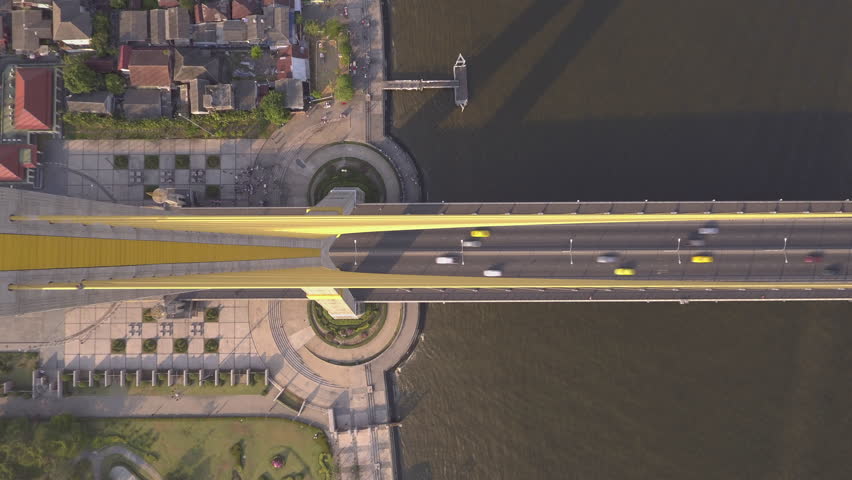 time lapse shot of people travel across Chao-Phrya river on Rama viii bridge in Bangkok Thailand shot from above