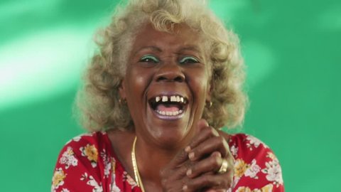 Old hispanic real people from Cuba with feelings and emotions, portrait of bizarre senior african american lady smiling, laughing and looking at camera. Elderly black woman with dental problems
