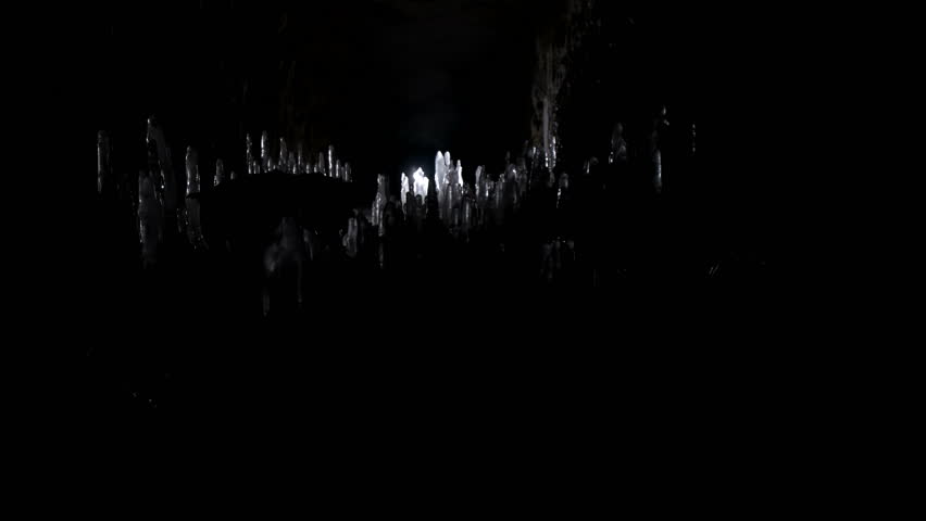 A scientist studying ice stalagmites in the cave