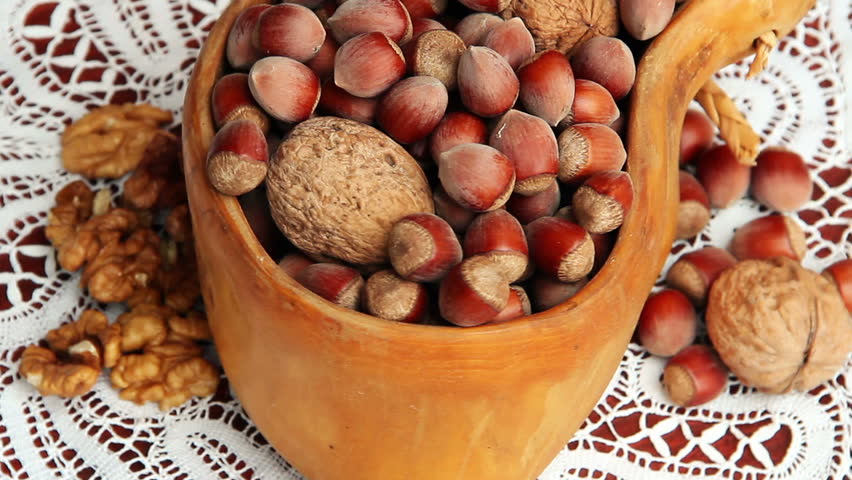 hazelnuts and walnuts in the beautiful traditional wooden bow on the table