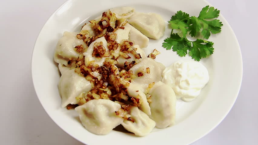 Russian national ravioli with onion on a plate rotation, on white plate and 